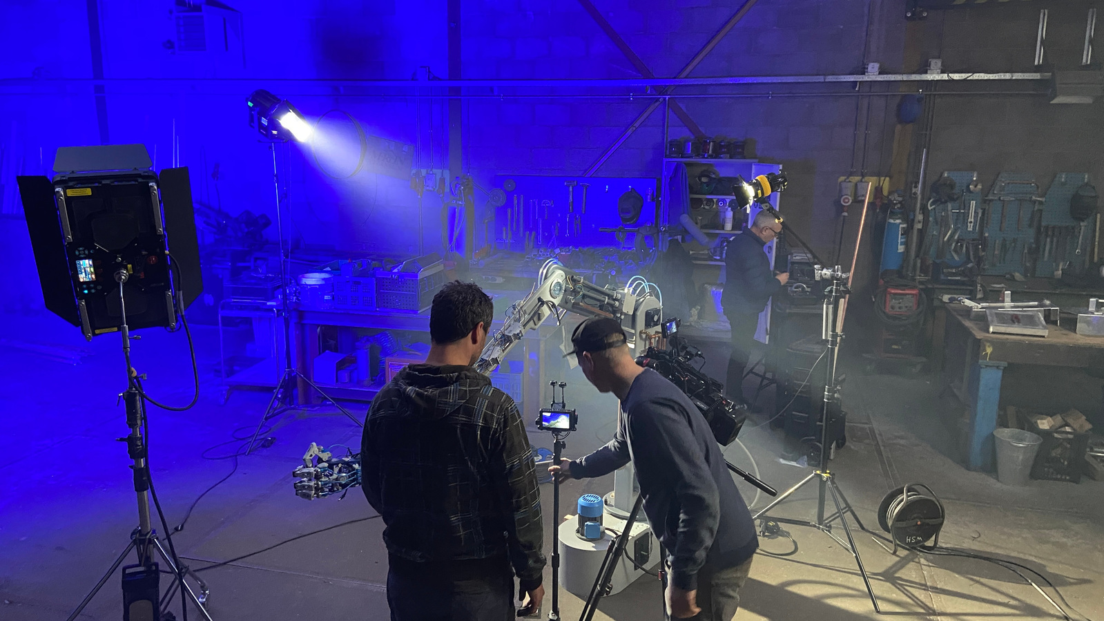 DOP and set designer behind the scenes at Technicum shoot at welding workshop.