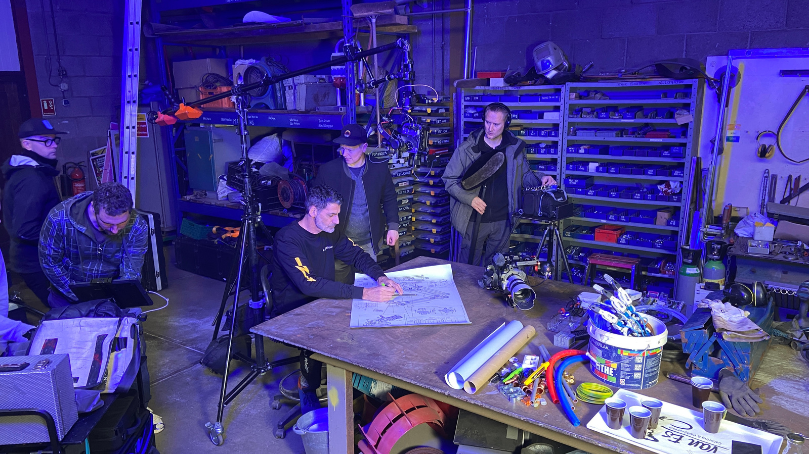 DOP, director, sound engineer and actor behind the scenes at Technicum shoot at welding workshop.
