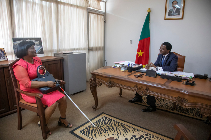 Eveline meets with the Mayor of Yaounde's 7th district, Mr Augustin Tamba, to discuss a project proposal she has written to set up income generating actives for people with visual impairments.