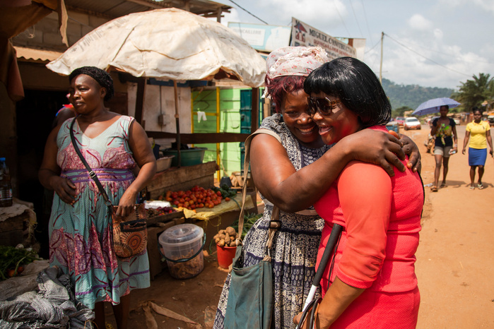 Eveline is hugging her youngest sister Fidelia who has a shop not far from her home. Fidelia, who used to live in the north west region of the country, has moved in Eveline's home recently to escape from the violence and troubles that have been hitting