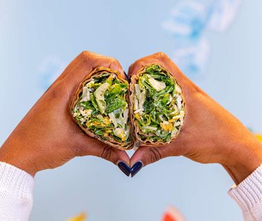 two hands make a heart while holding a Chopt wrap