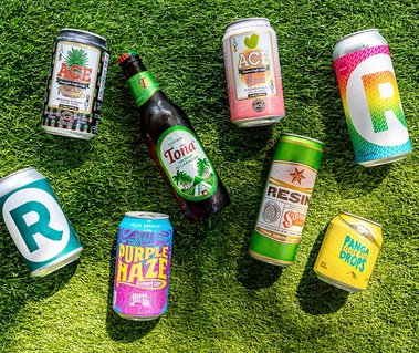 promotional photo of beers laying on fake grass