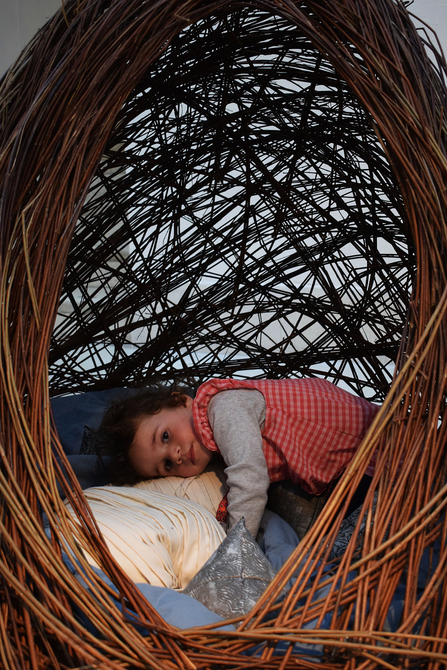 handwoven willow nest with child curled up inside
cosy
comfort space