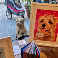 Nacho of the Four Legged Foodies poses with his Custom Pet Portrait by Woof Portraits in the window of Papersmiths at the Chelsea Dog Day event 2022