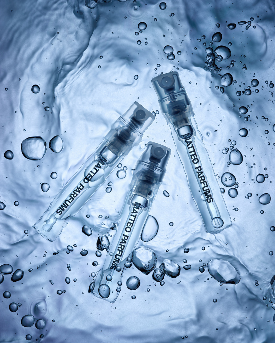 A trio of Lovers' Dew fragrance by MATTEO PARFUMS submerged in water for a stunning luxury beauty product shot