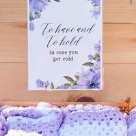 sign that reads "to have and to hold" attached to wooden box filled with hand made lap blankets