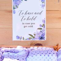 sign that reads "to have and to hold" attached to wooden box filled with hand made lap blankets