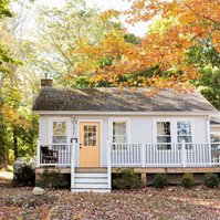 Cottage surrounded by autumn leaves