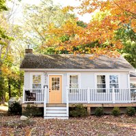 Cottage surrounded by autumn leaves