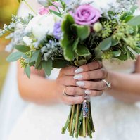 close up wedding bouquet, woman holding flowers with white painted nails for wedding