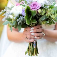 close up wedding bouquet, woman holding flowers with white painted nails for wedding