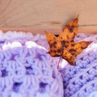 leaf on purple crocheted blanket