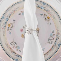 vintage floral place setting with napkin tied by silver napkin ring