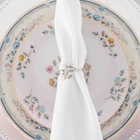 vintage floral place setting with napkin tied by silver napkin ring