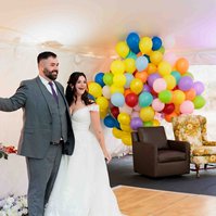 couple looking happy waving