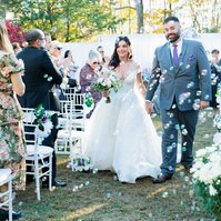 bride and groom walking through bubbles at wedding ceremony