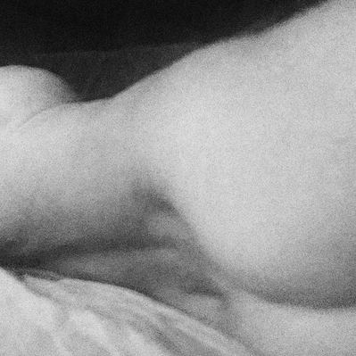A grayscale study of form and shadow, highlighting the curves of the body.