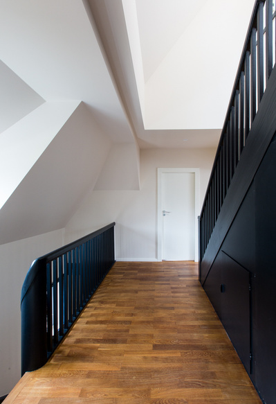 Corridor between two staircases in a renovated house. 
