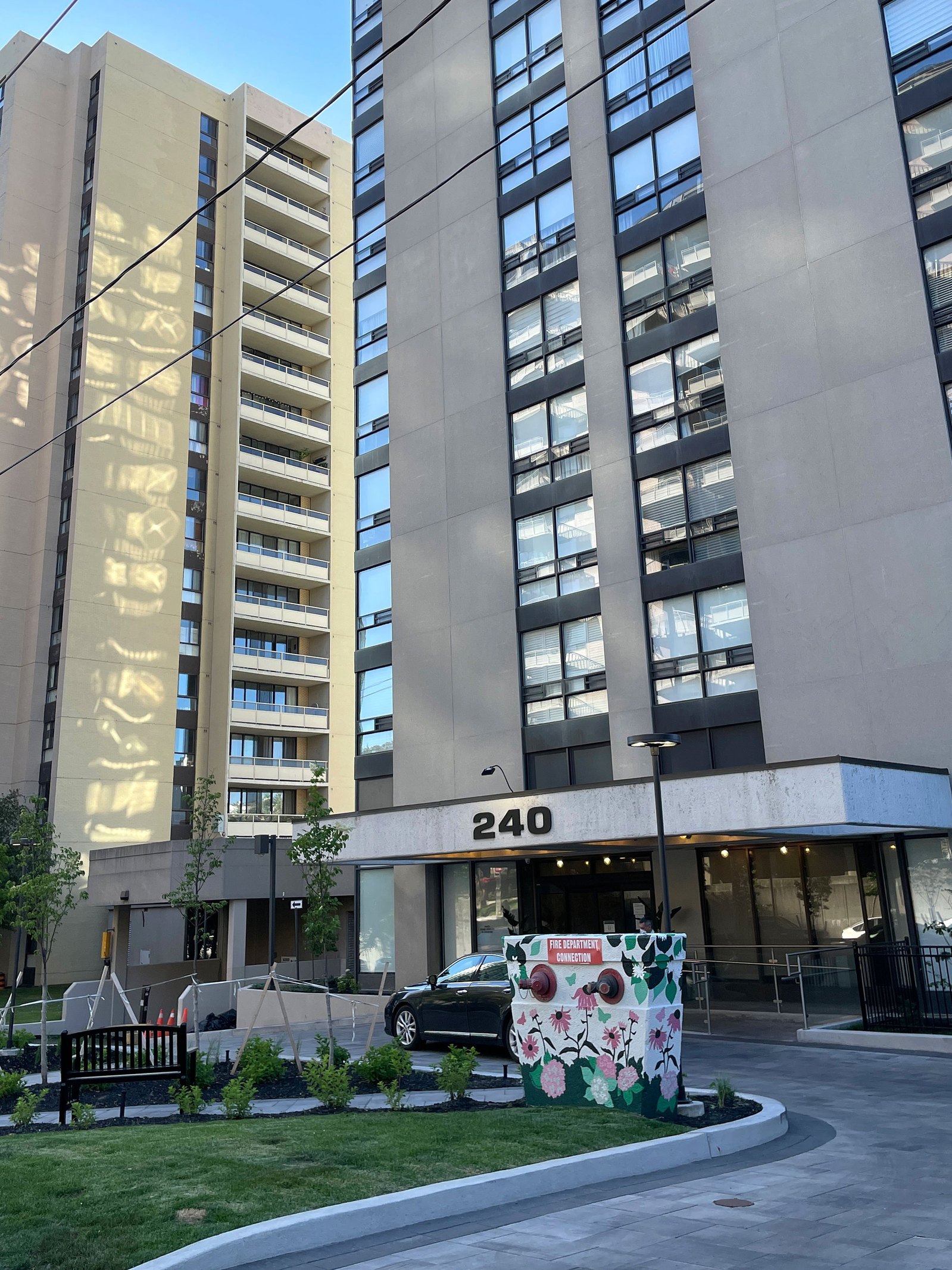 View of the front of a condo with a fire hydrant painted with a flower mural. 
