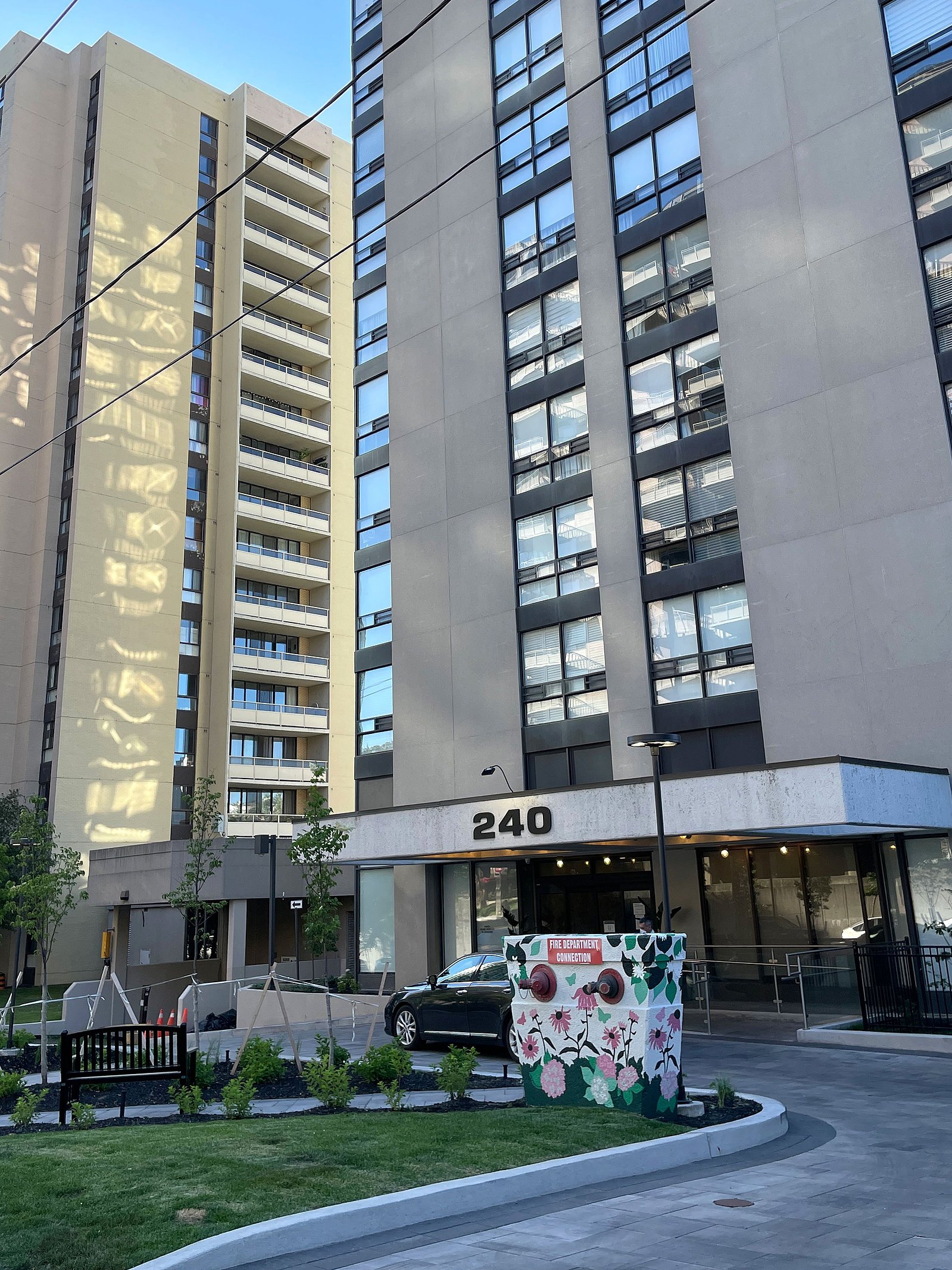 View of the front of a condo with a fire hydrant painted with a flower mural. 