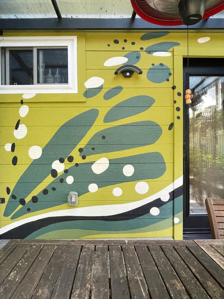 The butterfly pattern continues in natural colours of green, brown, and white to match the wasabi-green background. 