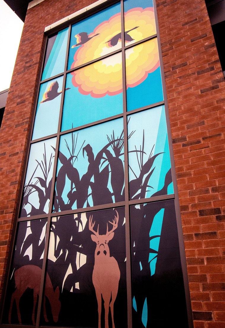 The tower features a sun, which is also the cross-section of a corn cob that represents the surrounding corn fields where you can find deer playing. 