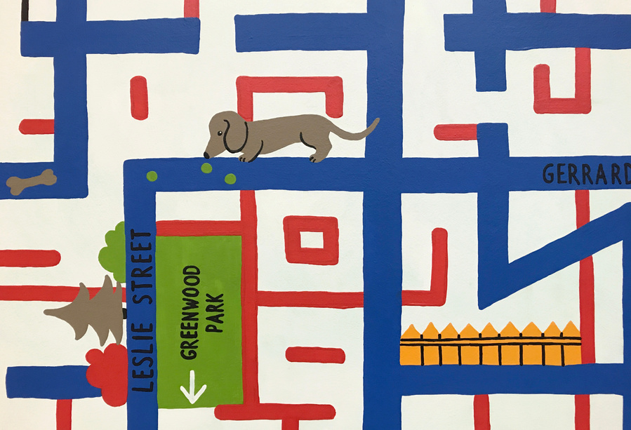 Detail of streets turned into a maze with a dashhound following a trail of treats.