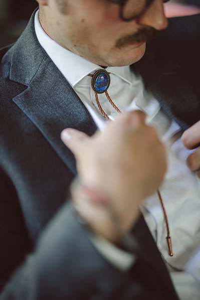 Groom wearing a bolo tie for his Milwaukee, Wisconsin wedding.  Tight shot of the bolo tie.