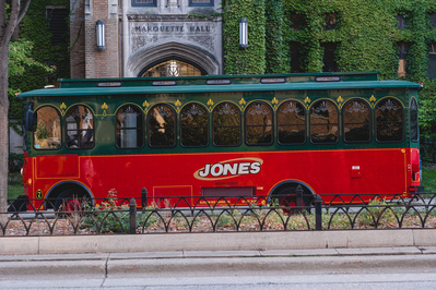 a trolley is parked on the marquette university campus on the wedding day of the couple in milwaukee, wisconsin.