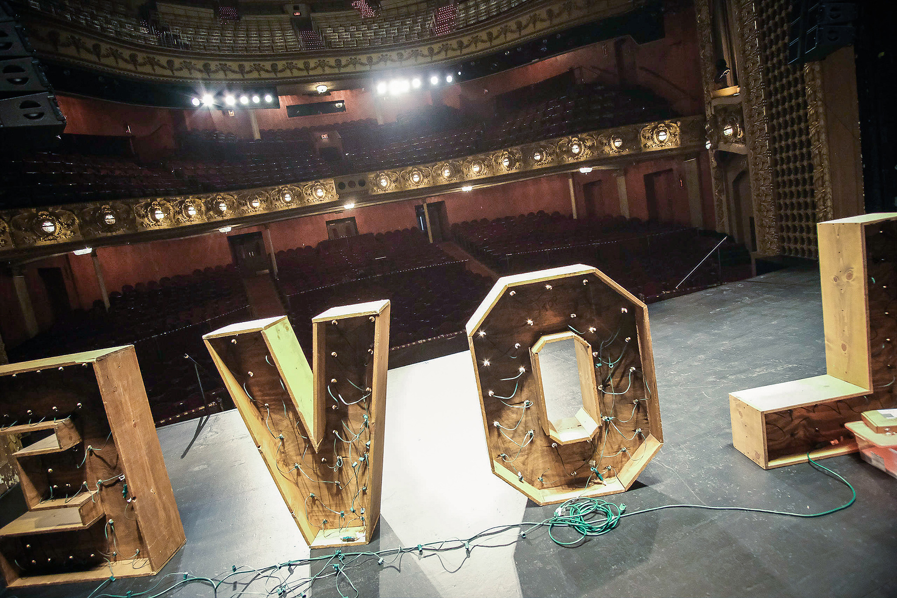 The Pabst Theater as one of the top wedding venues in Milwaukee.  Photograph is of the inside of the Pabst Theater from the stage, looking out over the word "LOVE" which is lit up with lights.