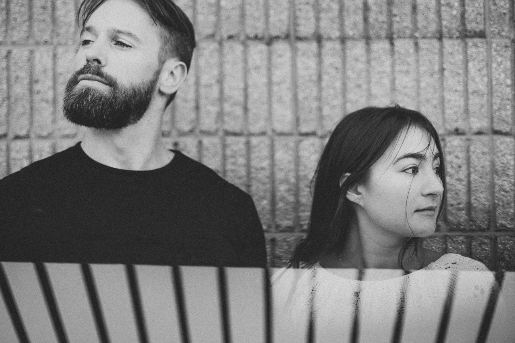 Black-and-white photo, couple stands together engagement session Milwaukee Wisconsin