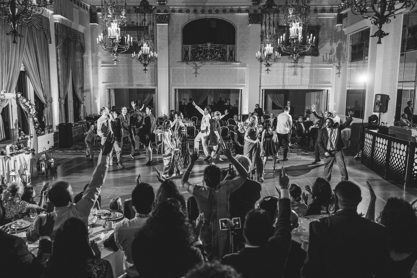 Black and White photo, wide dancefloor shot of choreographed dance at an Indian wedding.  Pfister hotel in Milwaukee, Wisconsin.