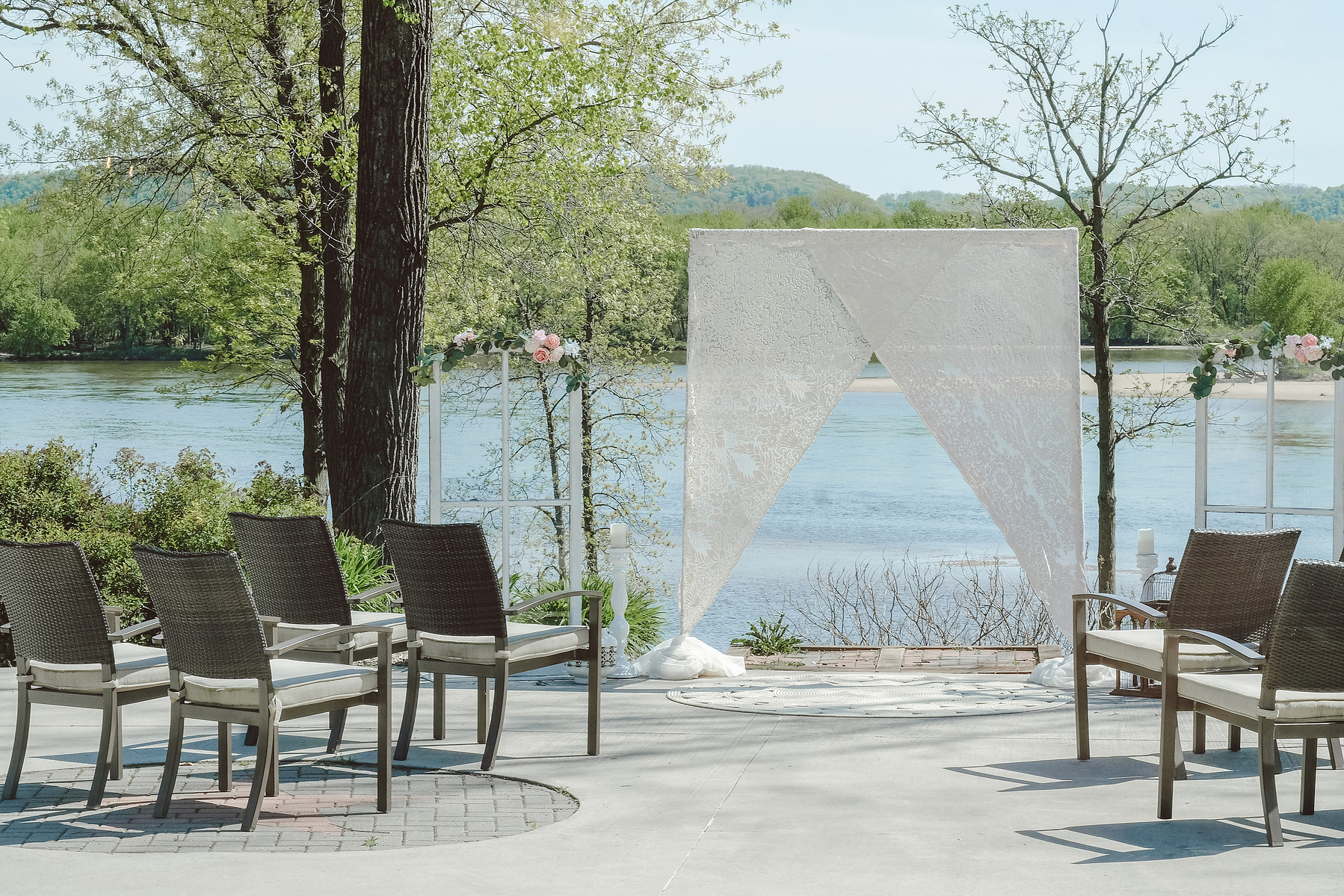Backyard wedding venue along the river outside of Madison, Wisconsin.  Guest seats lead the eye to the altar and backdrop.