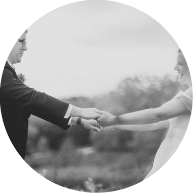 black and white photo of couple dancing on their wedding day.  smiling and laughing in a field, holding hands.  Madison wedding, photograph taken by Patrick Betcher of Betcher Photo.