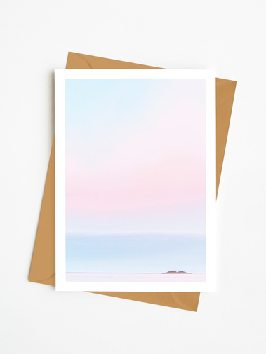 Portrait photographic greetings card of a small island in a pink and blue minimal seascape scene. A6 card with a 5 mm white border.