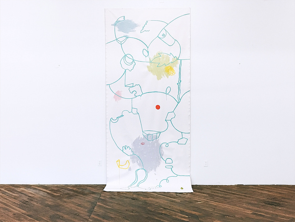 Long, hanging roll of canvas against wall with painted lines and colors. Touches wooden floor.