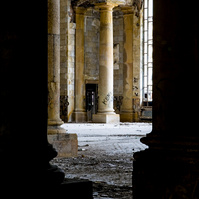 Ford Michigan Central Station, an evocative silhouette of two majestic columns standing strong while a distant crumbling facade signifies its storied past.