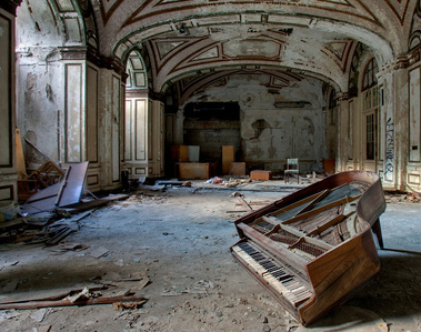 Step into the haunting beauty of Lee Plaza, an abandoned building in Detroit, MI. Witness a baby grand piano, leaning on its last leg, as streaks of light create an ethereal atmosphere from left to right. Explore the forgotten allure of decay in this capt