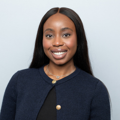 Corporate portrait headshot on a grey backdrop with clean lighting and neutral expression