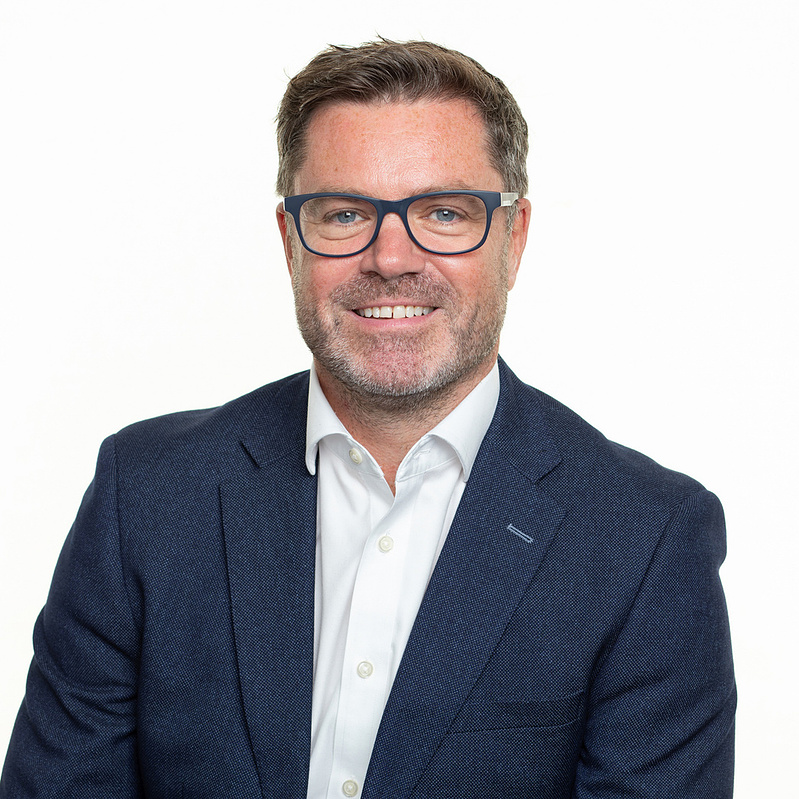 Professional business headshot taken in studio on a white background