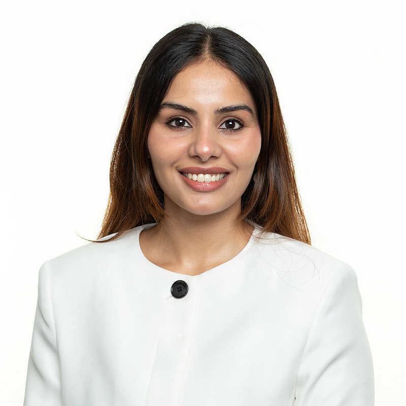 orporate headshot portrait on a white backdrop with neutral lighting