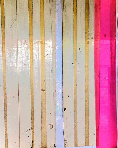 The 20 foot long white and hot pink dirty discolored plastic flaps of a delivery area at a big building in Brooklyn, NY. 