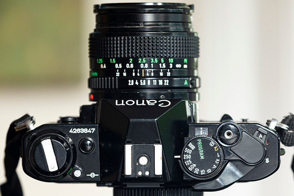A top-down view of the Canon AE-1 Program, showcasing its shutter speed dial, Program mode switch, and film advance lever. A well-designed SLR for 35mm film photography.