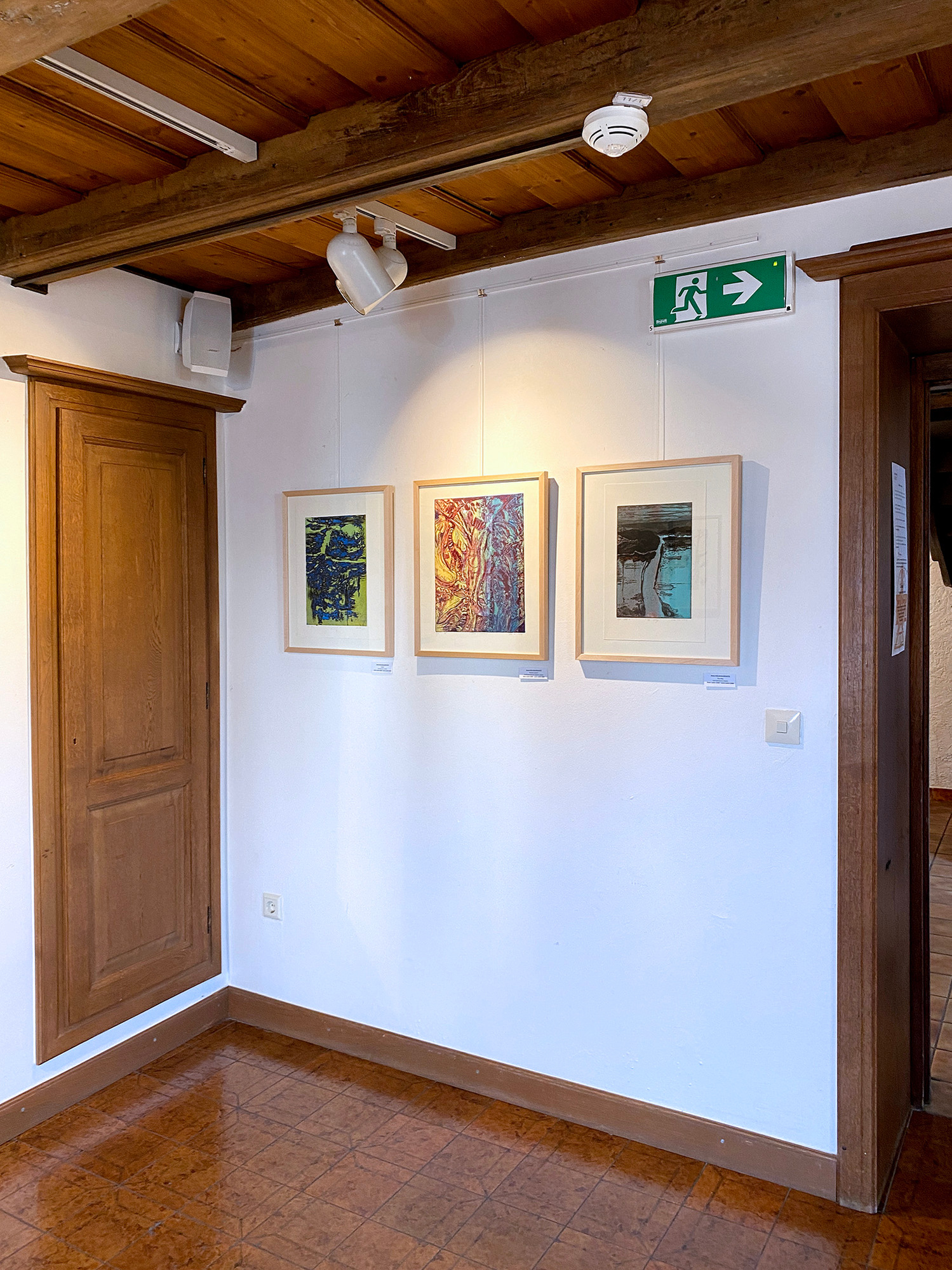Three printmaking artworks by Asta Kulikauskaite Krivickiene hanging in the exhibition "DRUCKREIF: Empreinte stellt aus" in Steinsel, Luxembourg.