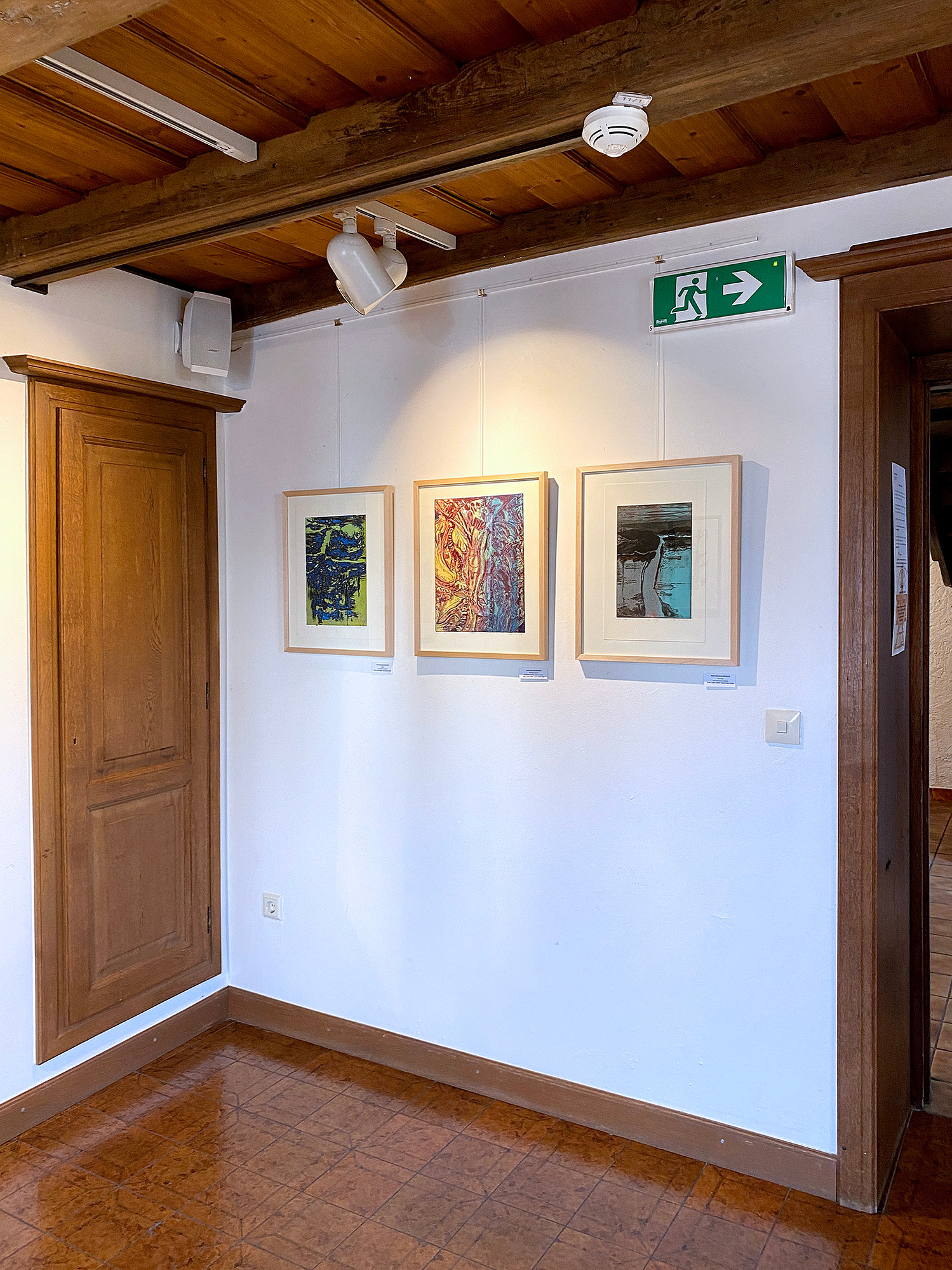 Three printmaking artworks by Asta Kulikauskaite Krivickiene hanging in the exhibition "DRUCKREIF: Empreinte stellt aus" in Steinsel, Luxembourg.