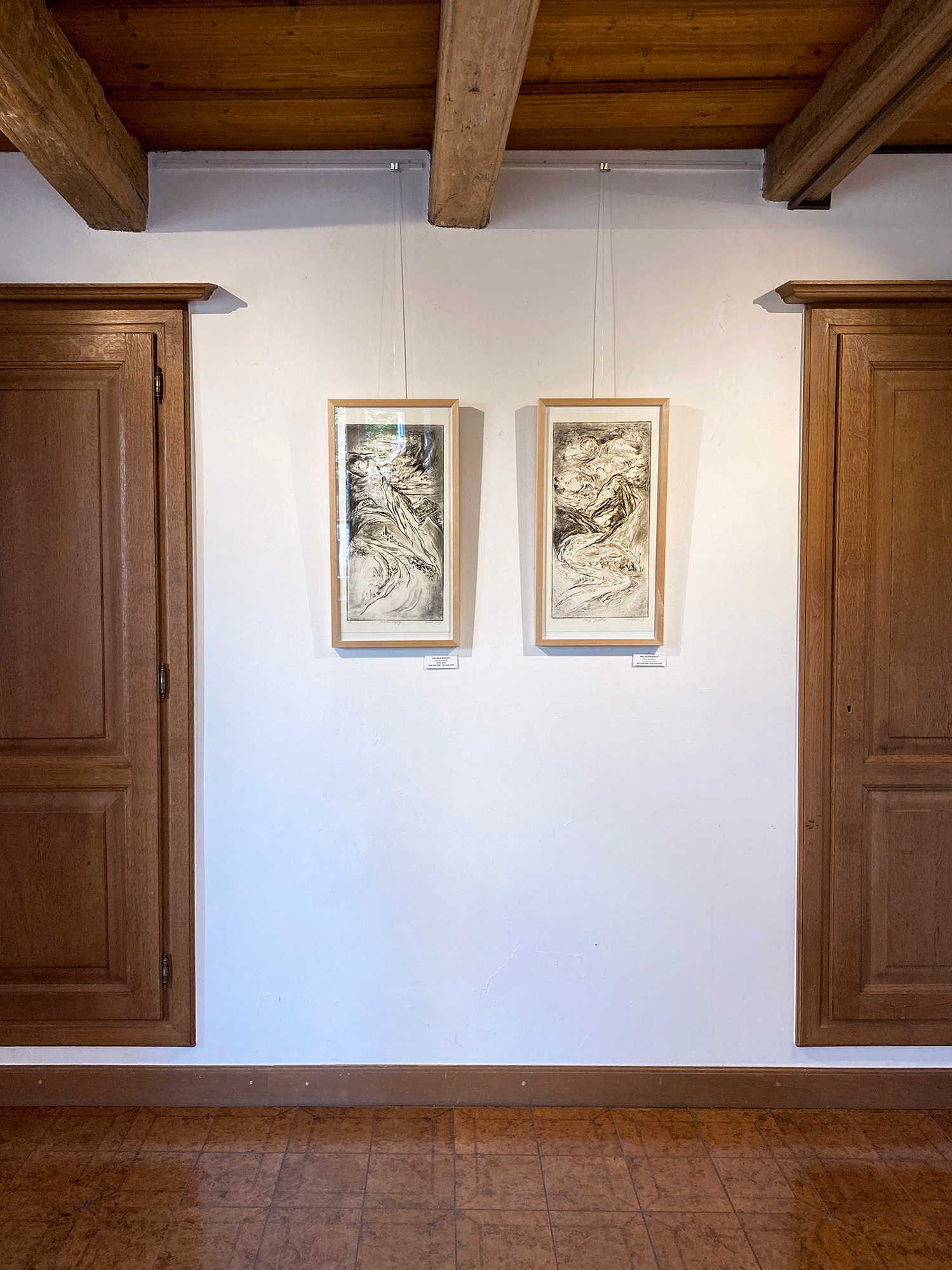 Twoprintmaking artworks by Asta Kulikauskaite Krivickiene hanging in the exhibition "DRUCKREIF: Empreinte stellt aus" in Steinsel, Luxembourg.