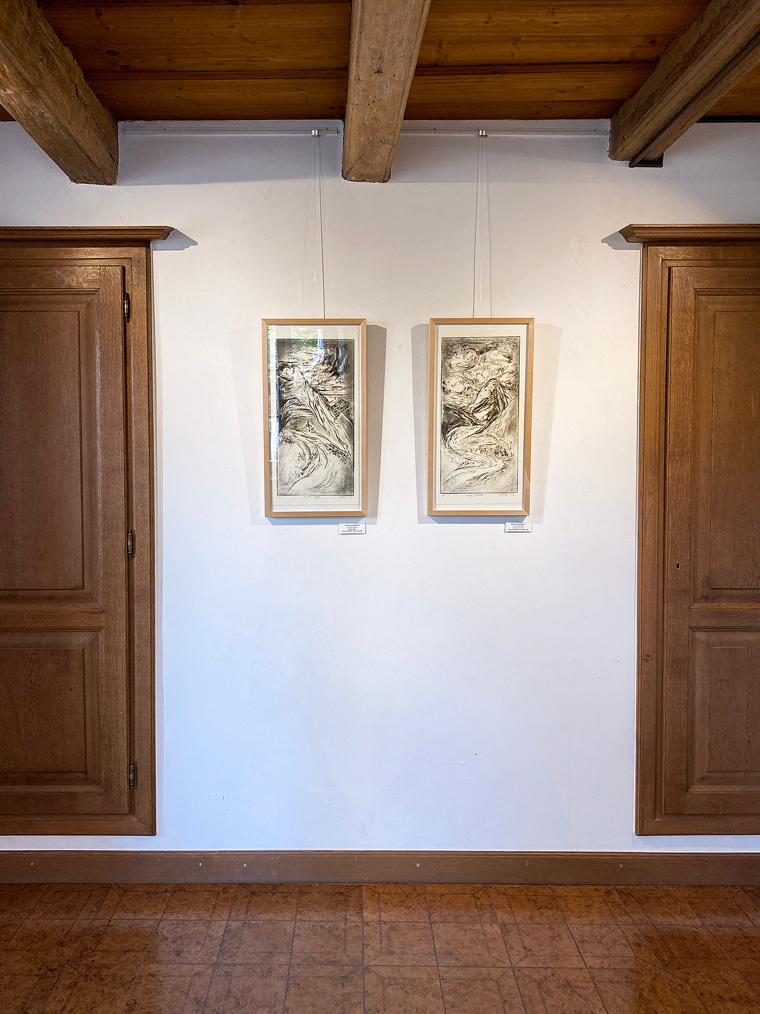 Twoprintmaking artworks by Asta Kulikauskaite Krivickiene hanging in the exhibition "DRUCKREIF: Empreinte stellt aus" in Steinsel, Luxembourg.