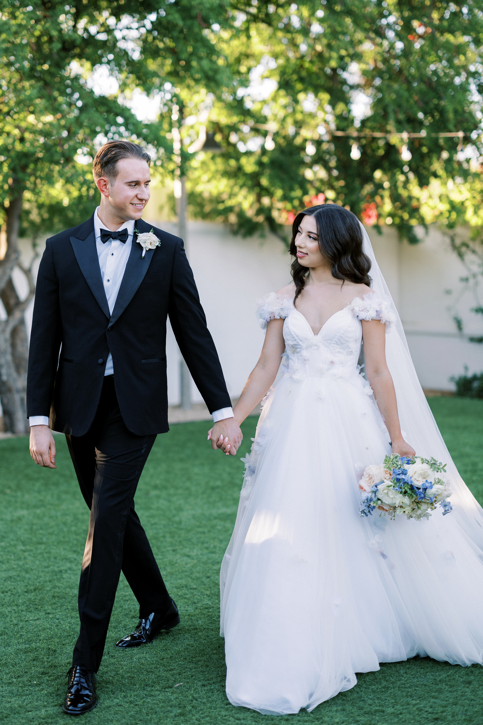 A bride and groom taking a stroll after getting married at El Chorro Arizona 