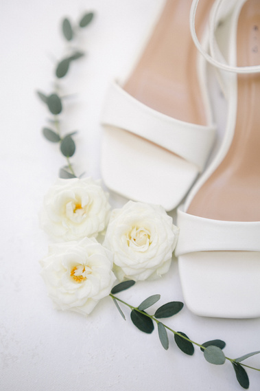 A flatlay with shoes and flowers and greenery to display details on a wedding day
El Chorro