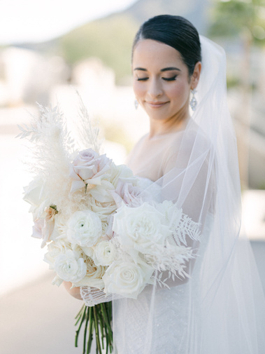 A photograph of a Bride on her wedding day holding a bouquet at Mountain Shadows Resort in Paradise Valley Arizona Scottsdale
